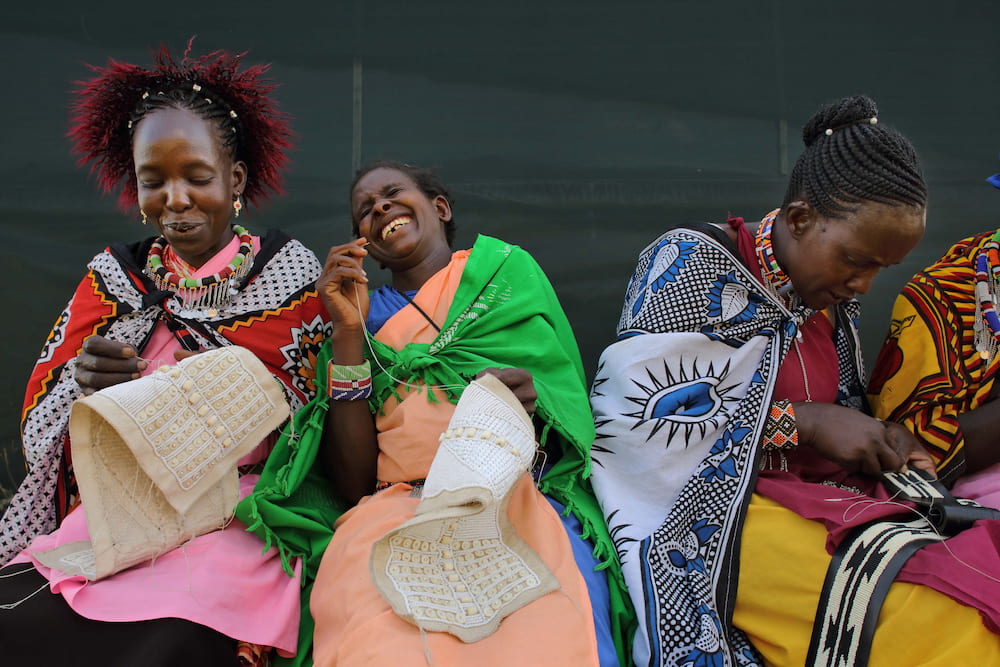 Ladies creating beadwork at The Maa Trust.