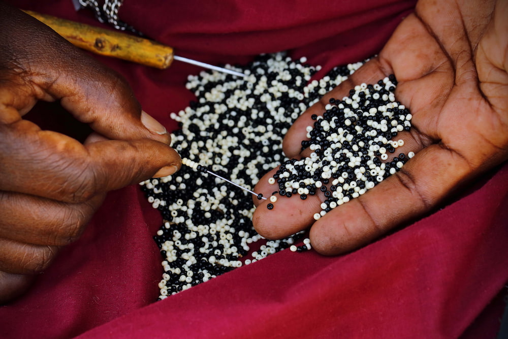 The intricate process of threading beads.