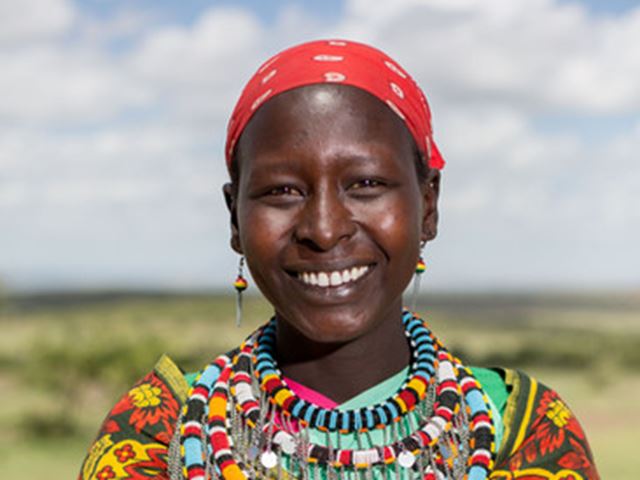Maasai Lady Holding A Bottle Of Honey