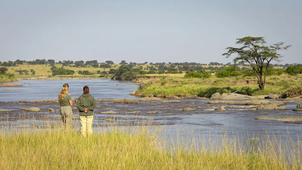 Two female guides look out over a river