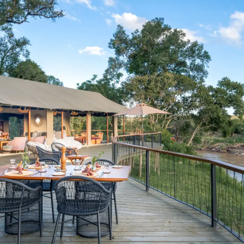 Adining set up on the spacious wooden deck at Rekero shows how close the river is