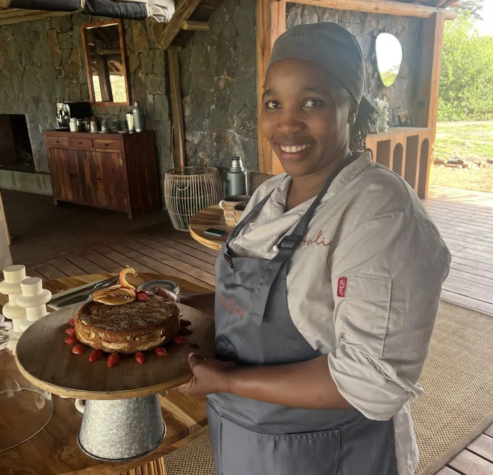 Chef Diana serves a freshly baked cake in the camp | Asilia Africa
