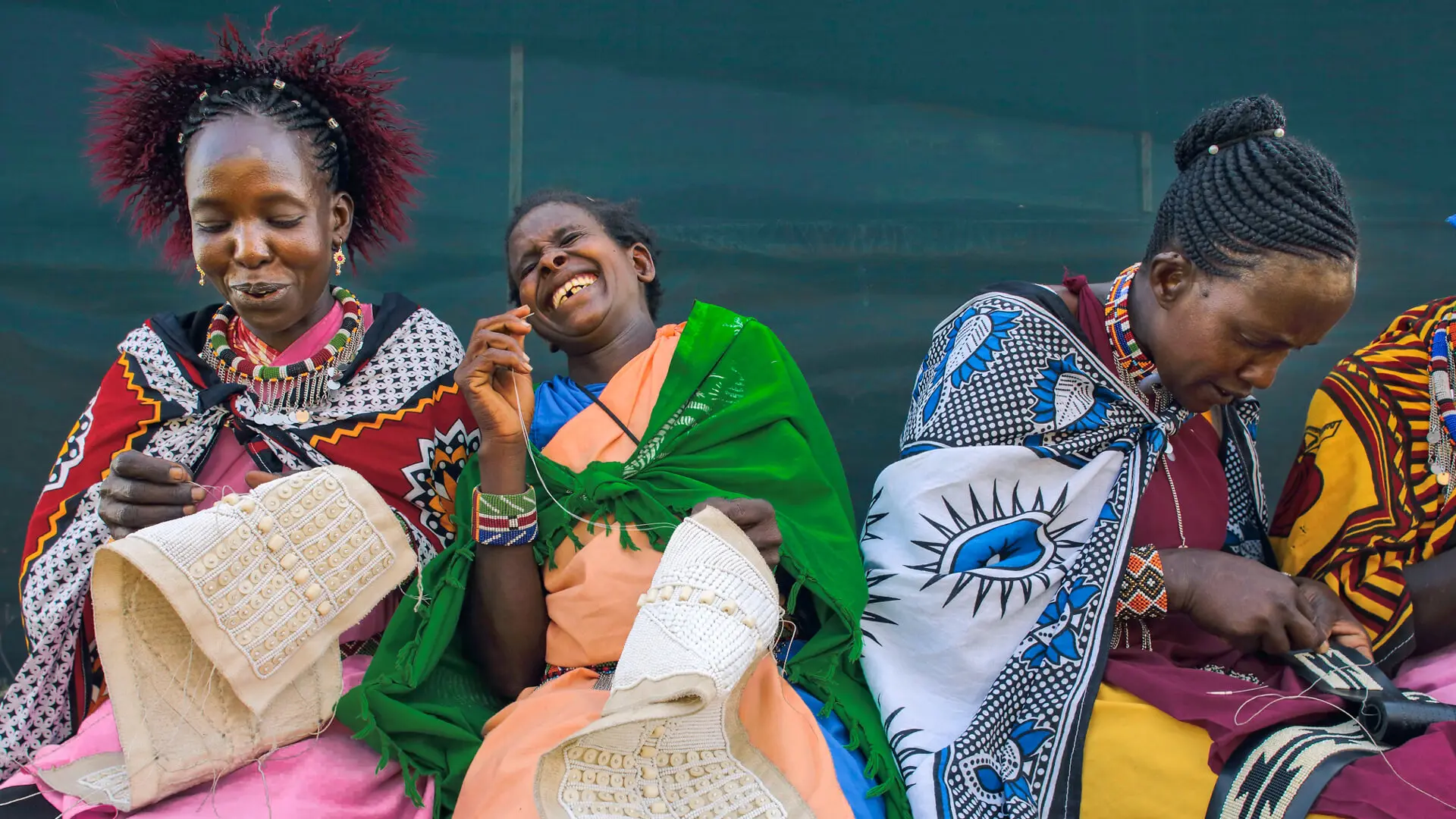 A group of Maasai women sew and share a laugh