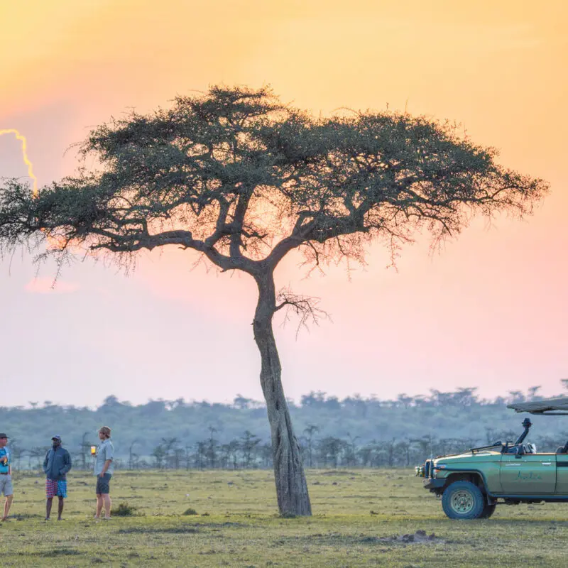 Stopping for a sundowner drink on an afternoon game drive in Kenya