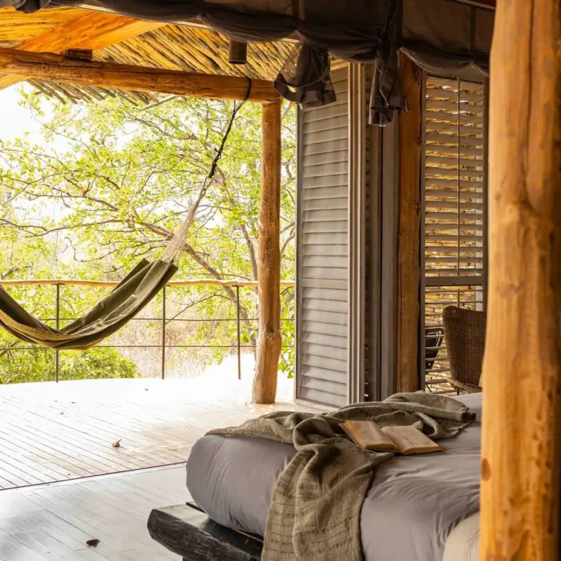 Jabali Private House, hammock swaying on a deck through open shutter doors