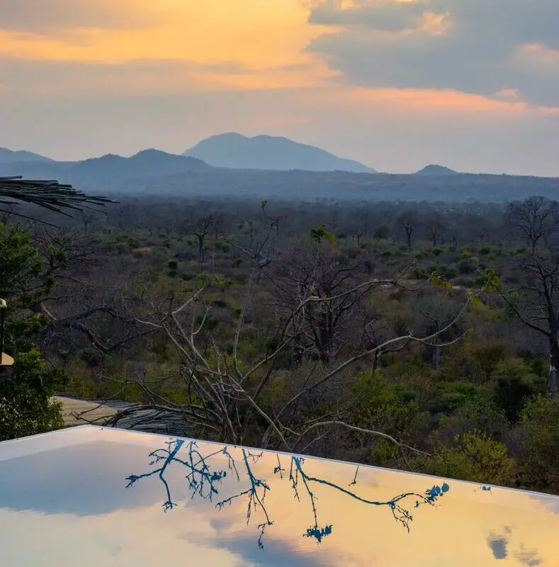 Jabali Ridge, Ruaha National Park, infinity pool reflecting the sky at sunset