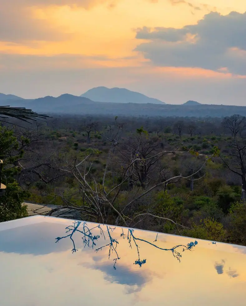 Jabali Ridge, Ruaha National Park, infinity pool reflecting the sky at sunset
