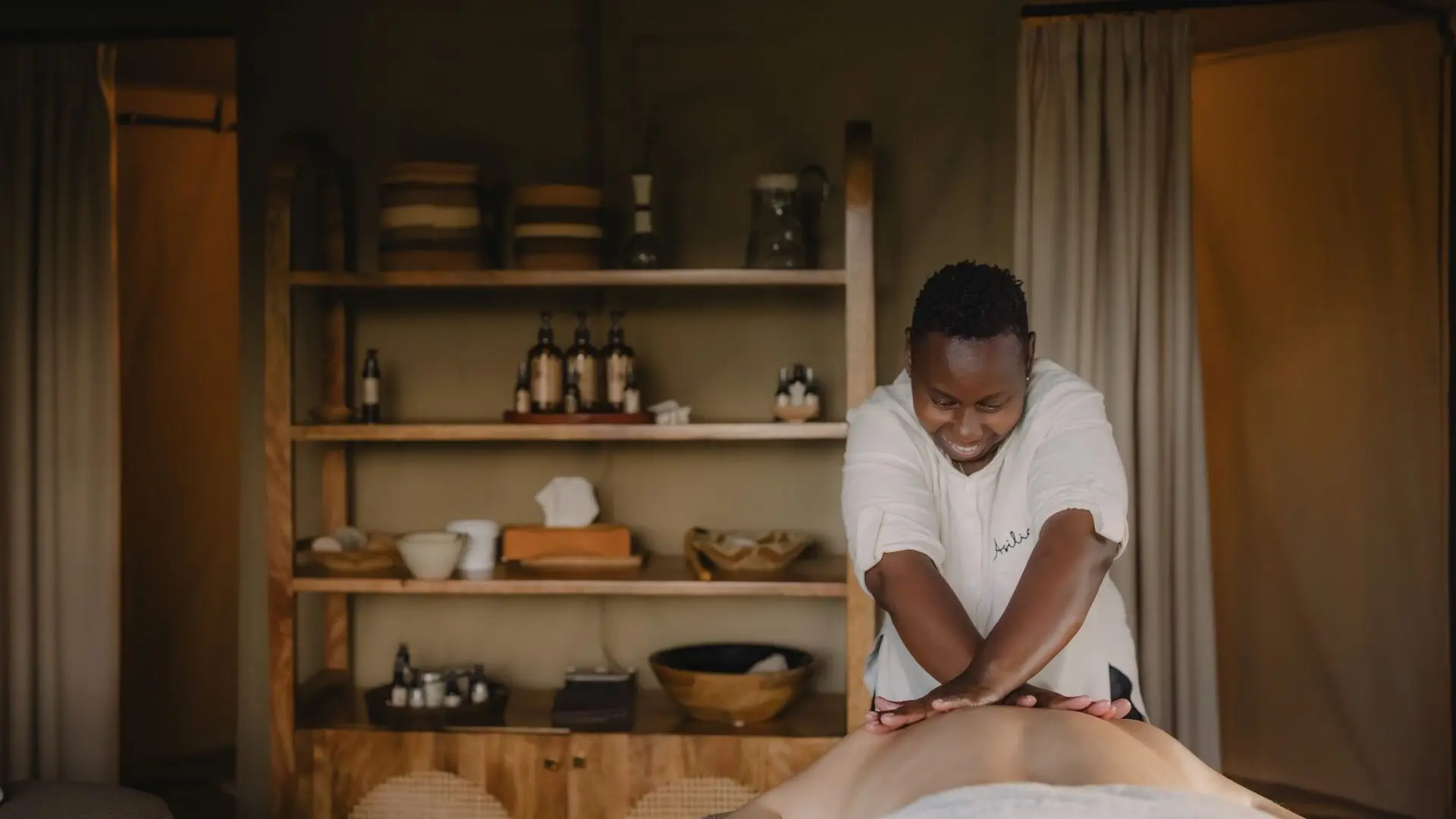 A masseuse performing a massage treatment for a guest staying at Naboisho Camp in the Mara Naboisho Conservancy, Kenya.