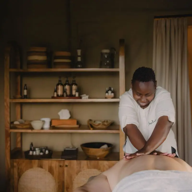 A masseuse performing a massage treatment for a guest staying at Naboisho Camp in the Mara Naboisho Conservancy, Kenya.