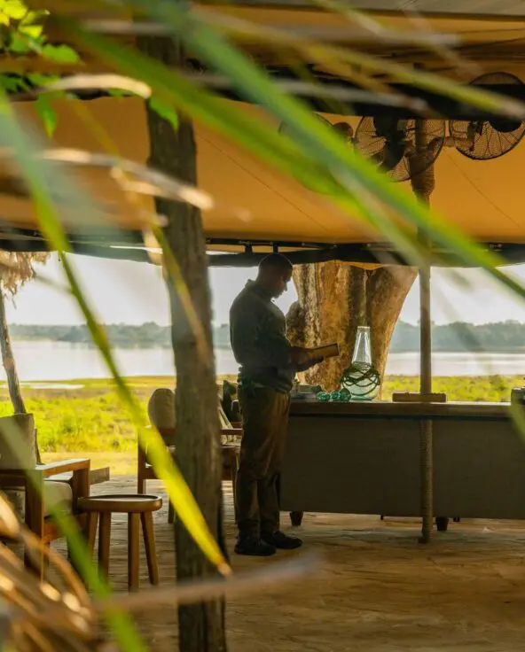 Roho ya Selous' open lounge area with seating facing the river and green landscape