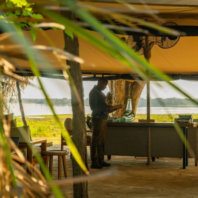 Roho ya Selous' open lounge area with seating facing the river and green landscape