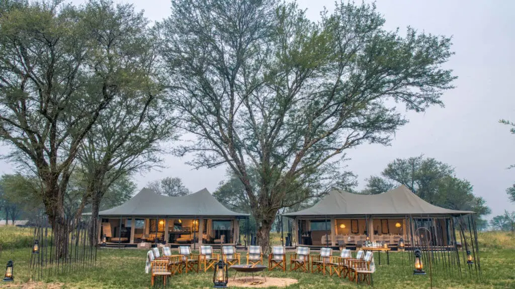 Exterior view of Ubuntu with the boma in the foreground - chairs arranged the camp fire