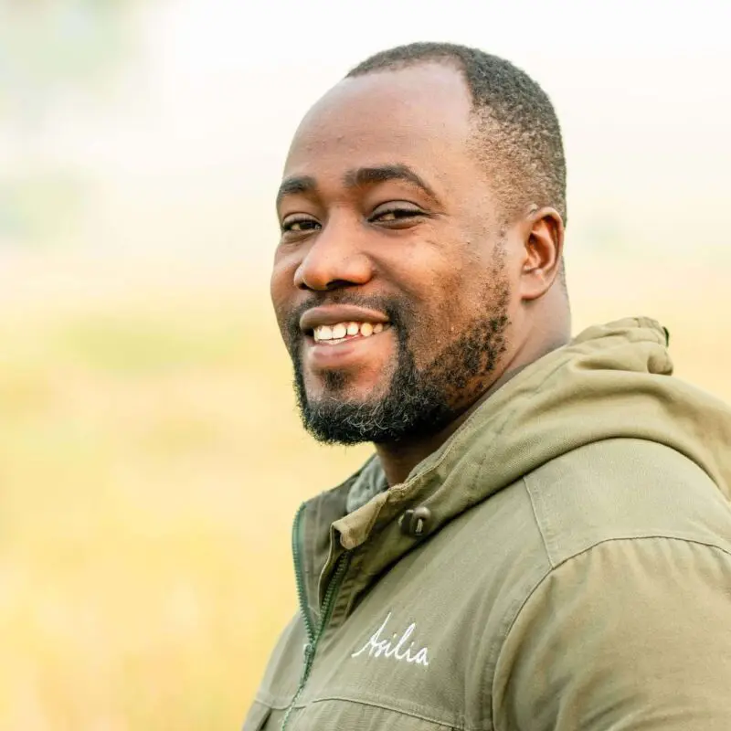 male safari guide smiling at the camera at ubuntu migration camp, tanzania, east africa