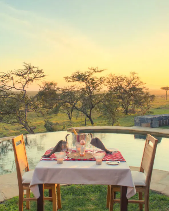 Outside view of poolside dining at sunset, naboisho camp, mara naboisho conservancy, kenya
