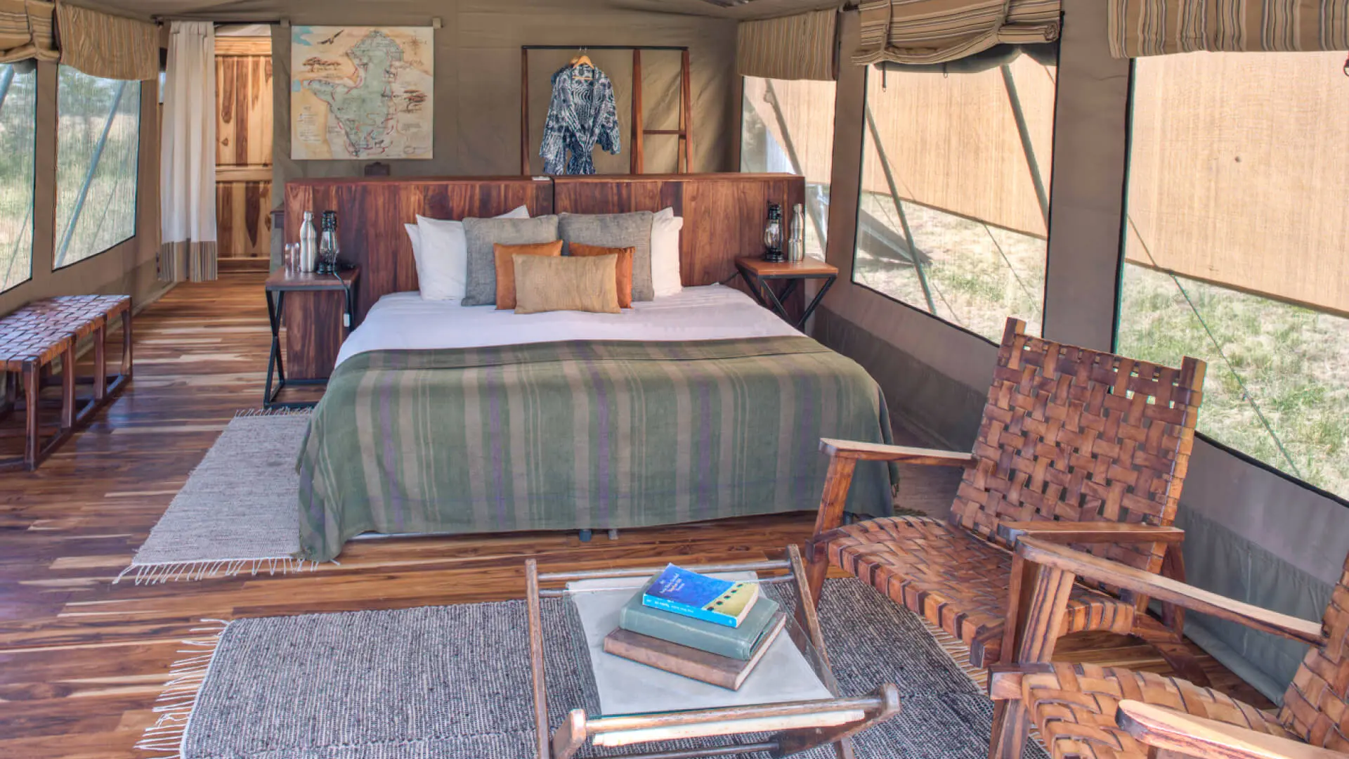 Asilia olakira migration Camp, inside guest tent, bed and chairs, Serengeti National Park, Tanzania