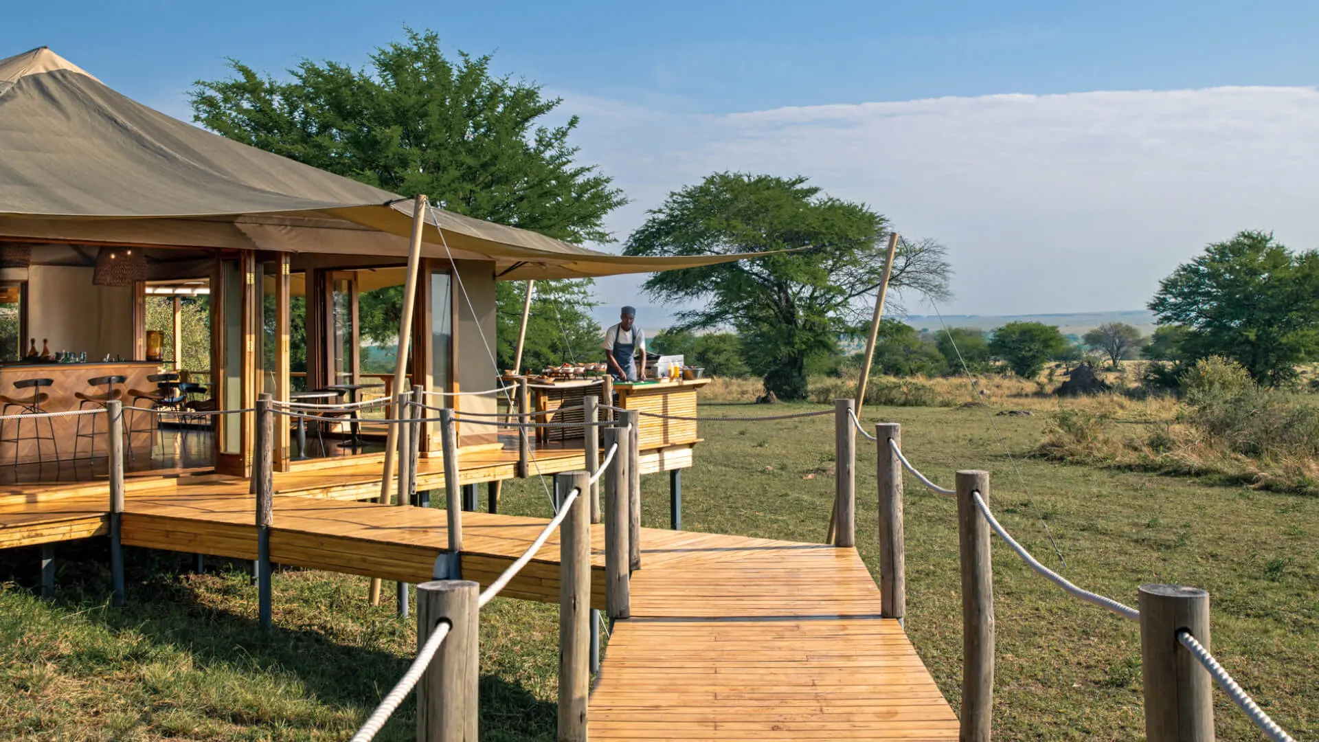 Sayari Camp, Northern Serengeti, chef doing lunch setup on the deck