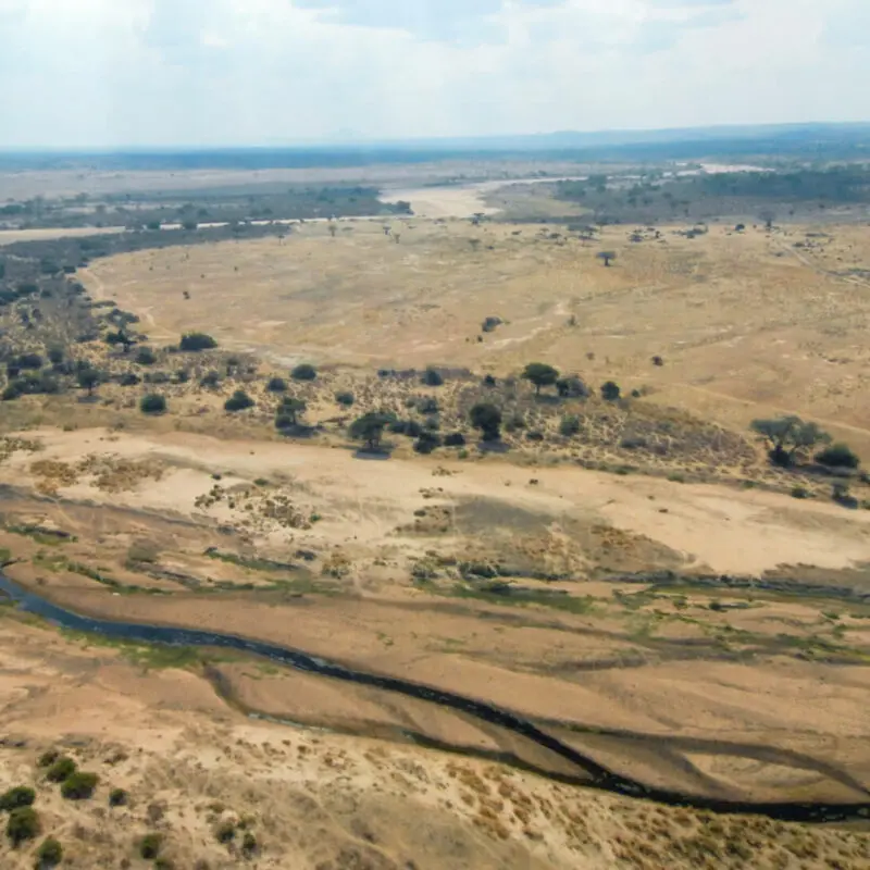 Usangu Expedition Camp, Ruaha National Park, landscape, river flowing, trees and bushes surrounding, dry land