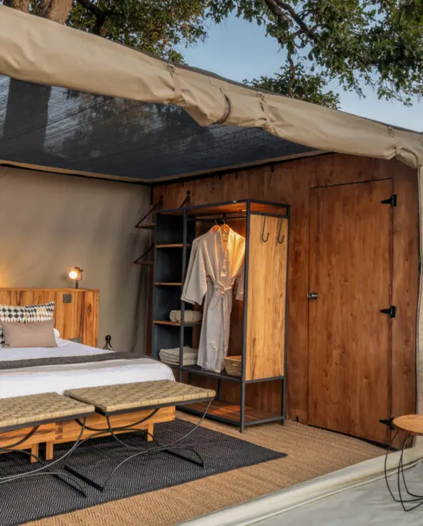 Interior view of a Kokoko tent, showing the roof pulled back and the overhead netting