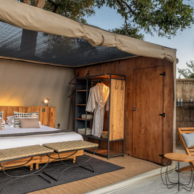 Interior view of a Kokoko tent, showing the roof pulled back and the overhead netting