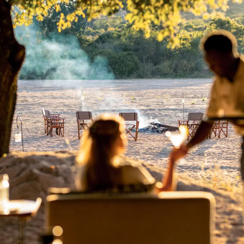 A guest enjoys a quiet moment while being served a beverage