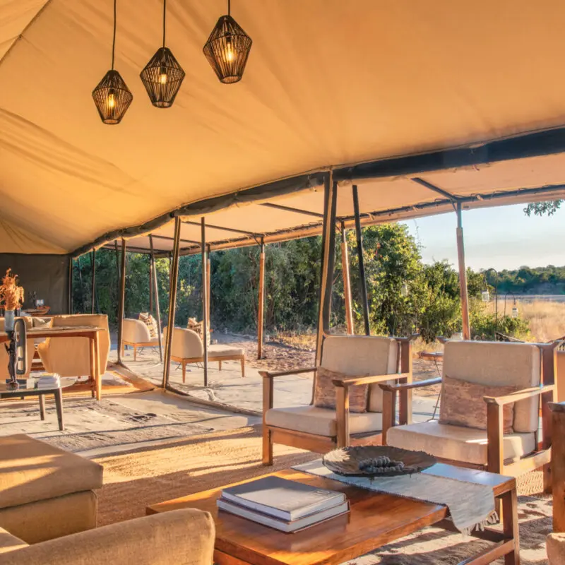 The tented lounge area at Kokoko, showing comfortable chairs and tables where guests can relax