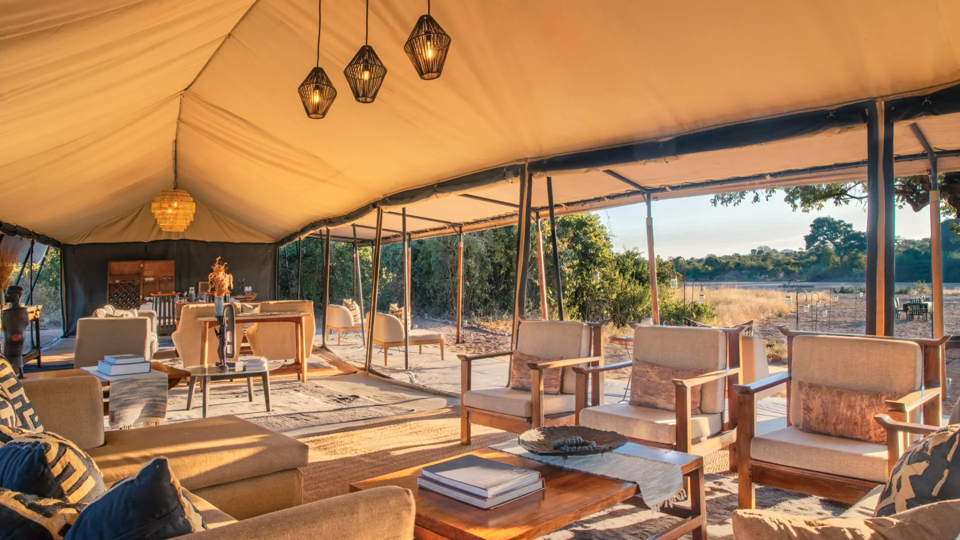 The tented lounge area at Kokoko, showing comfortable chairs and tables where guests can relax