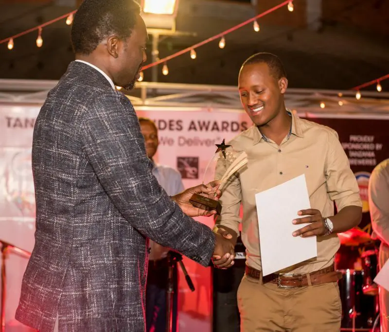 An Asilia guide accepts an award | Asilia Africa