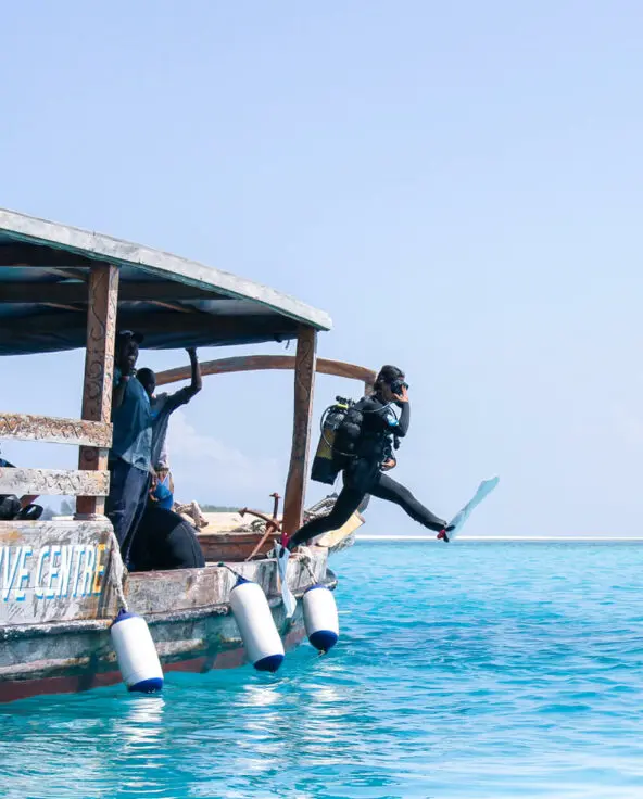 Scuba diver jumping off the boat in zanzibar