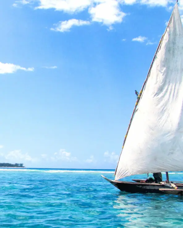 A boat sailing on the crystal blue waters in zanzibar