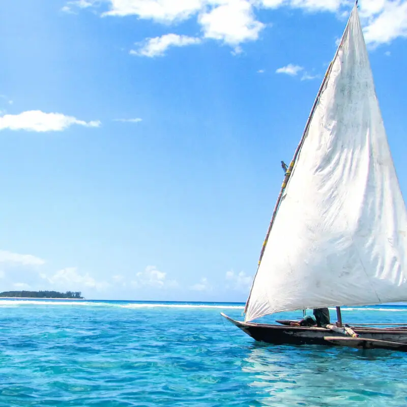 A boat sailing on the crystal blue waters in zanzibar