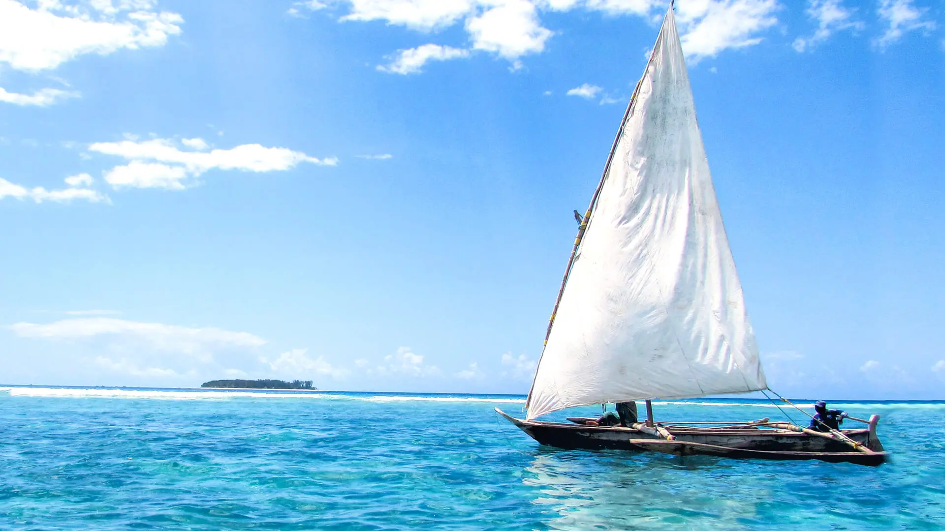A boat sailing on the crystal blue waters in zanzibar