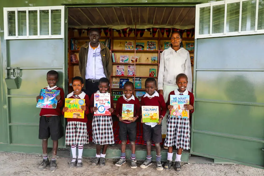 Happy teachers and children outside the Save our Savanna library