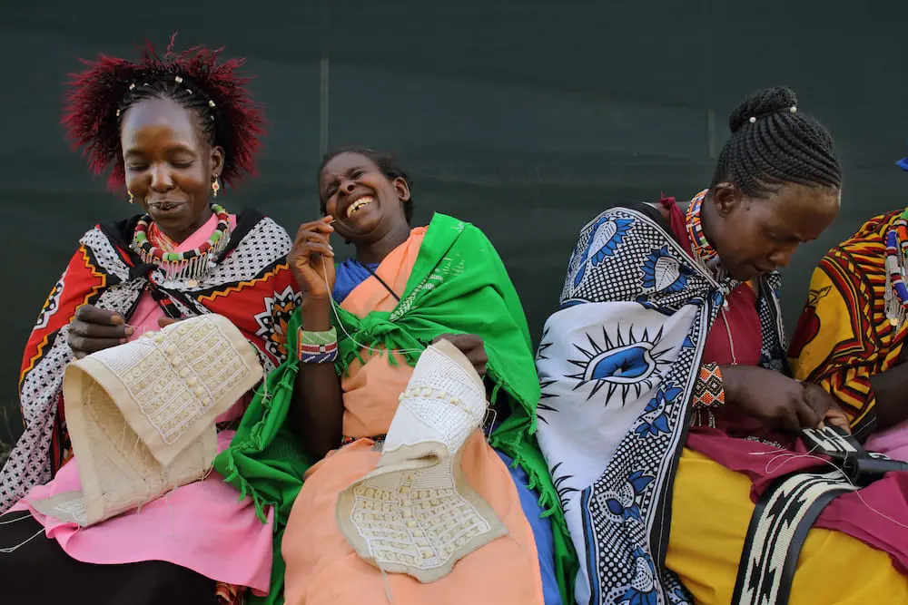 Ladies creating beadwork at The Maa Trust