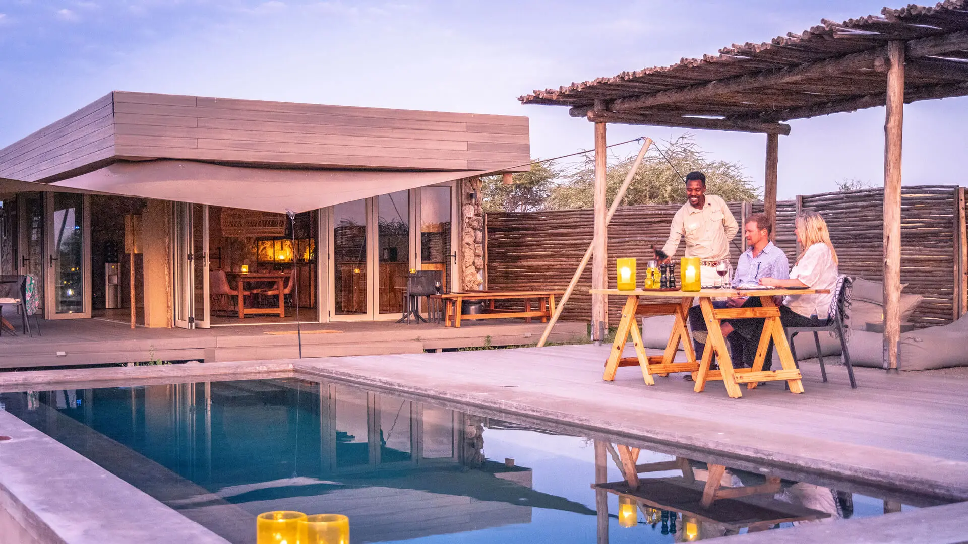 A couple enjoy a private evening meal at Namiri Plains Retreats in Tanzania - Asilia Africa