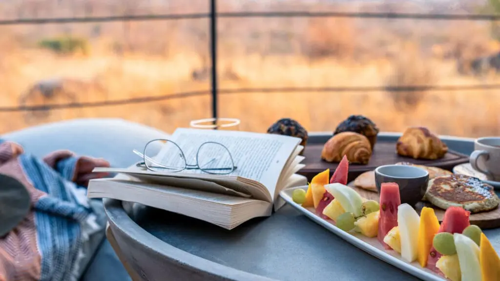 Breakfast on a table with a guest's book - a morning well spent