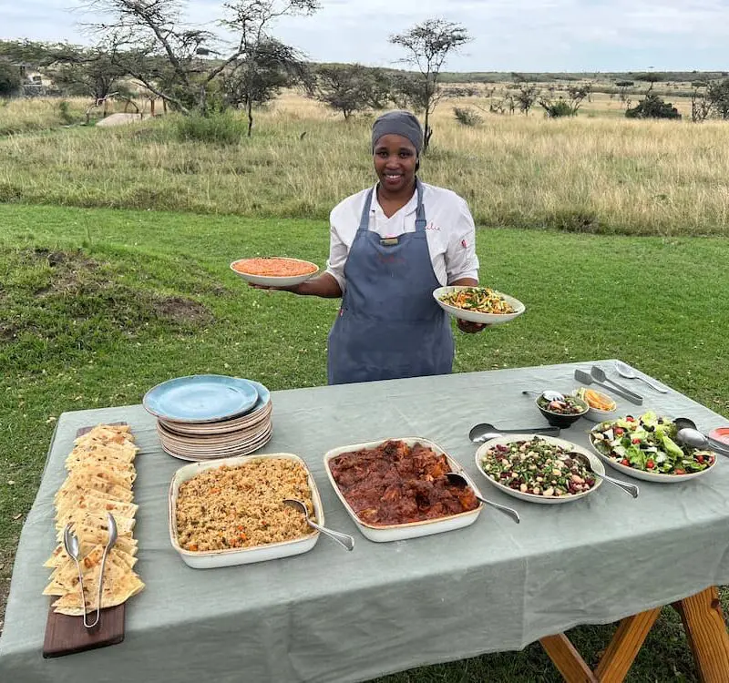 Diana, Head Chef at Naboisho Camp, serves a colourful lunch outdoors on the camp lawns | Asilia Africa