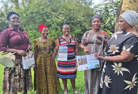 The four women display their finished products.
