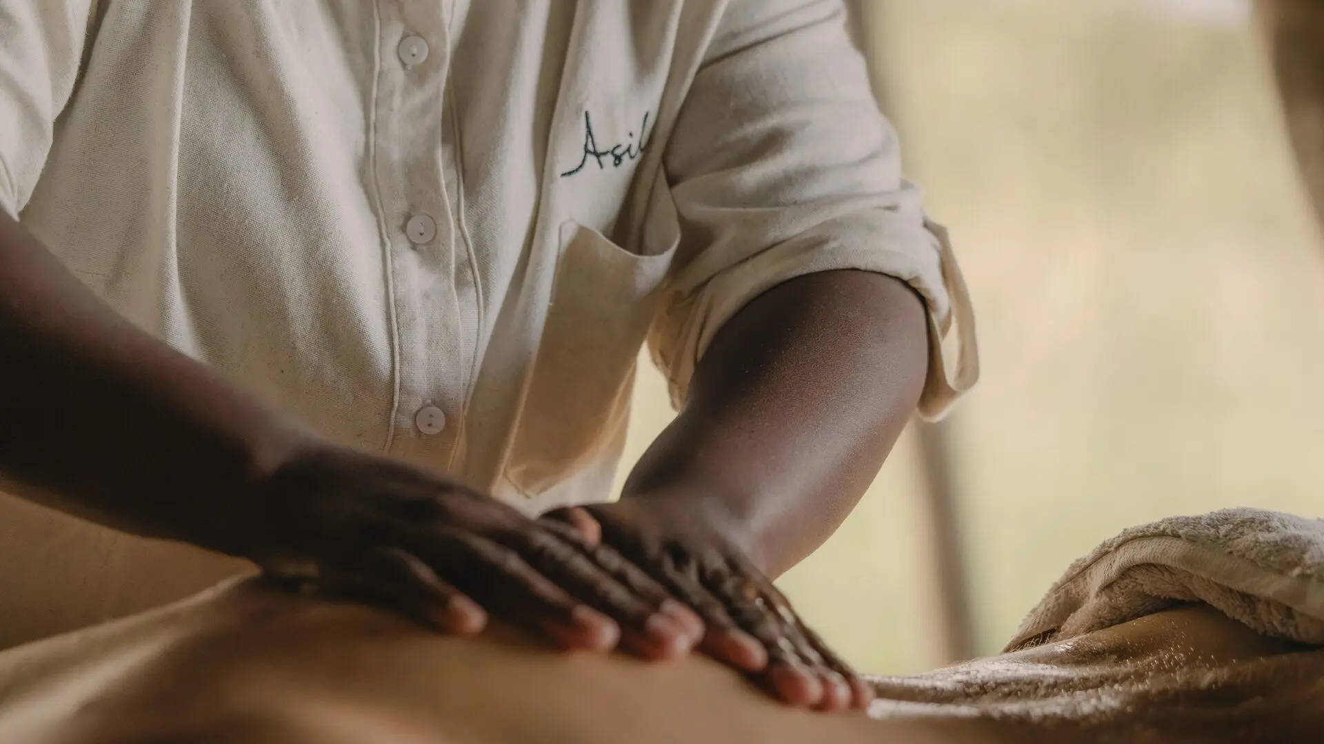 Close-up of a guest receiving a massage treatment at Naboisho Camp in Kenya.