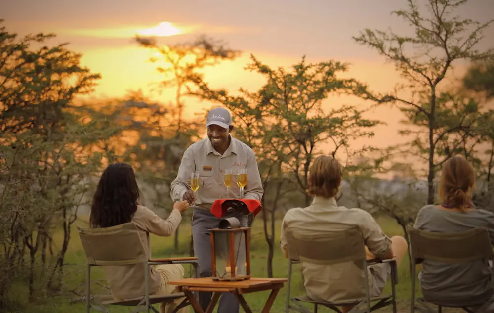 Naboisho Guests enjoying drinks at sunset