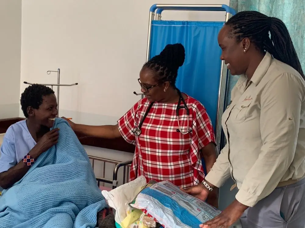 An Asilia staff member distributes Mama Kits to women in the clinic.