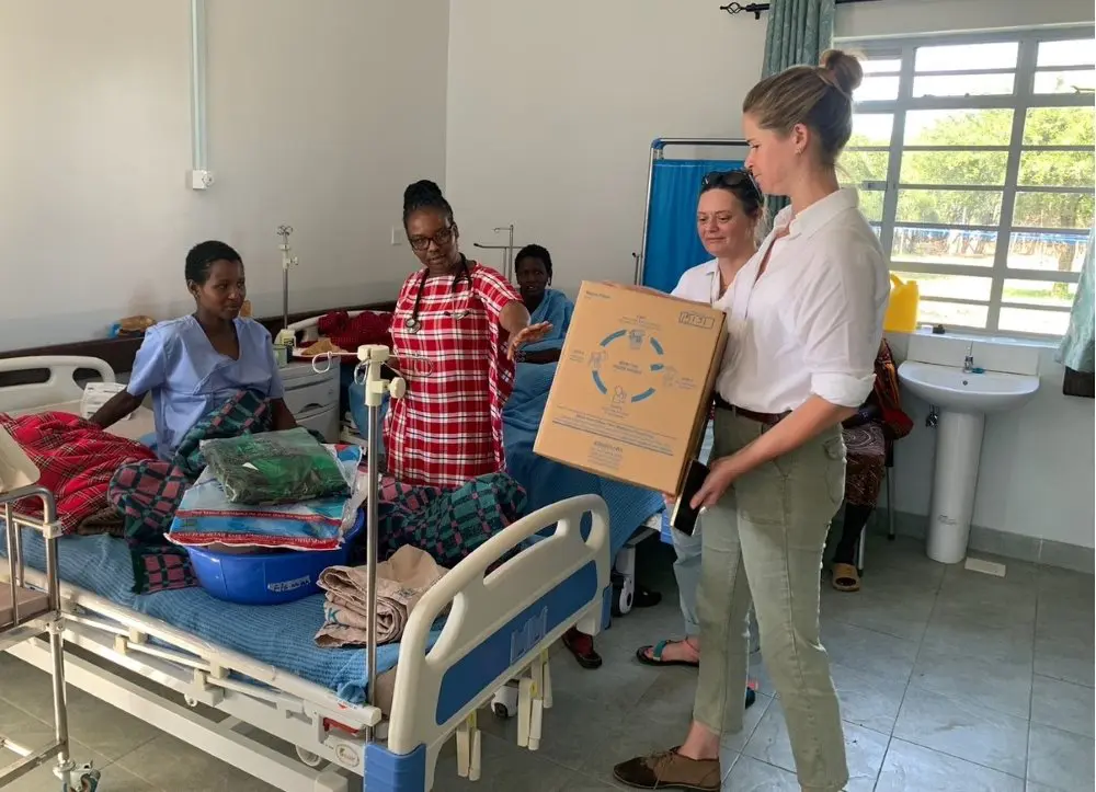Asilia staff distributing Mama Kits in the clinic, Kenya.