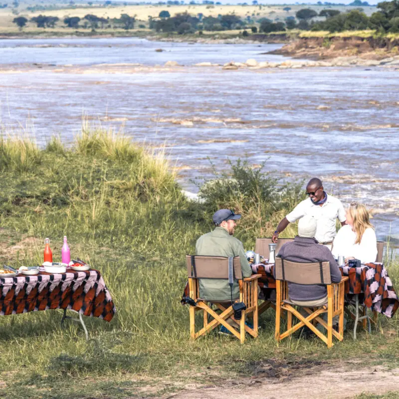 Serengeti National Park, lunch setup with guests and guide enjoying the view