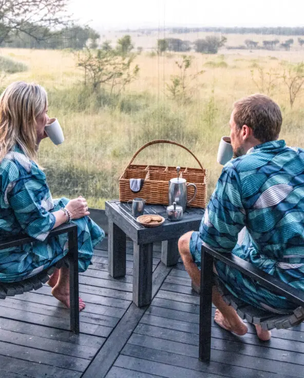 Serengeti National Park, guests in the morning, coffee, wake up call with biscuits, sitting on chairs with gowns
