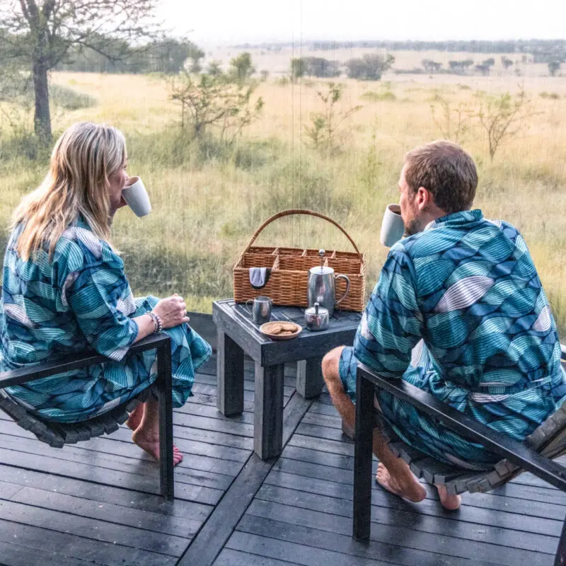 Serengeti National Park, guests in the morning, coffee, wake up call with biscuits, sitting on chairs with gowns