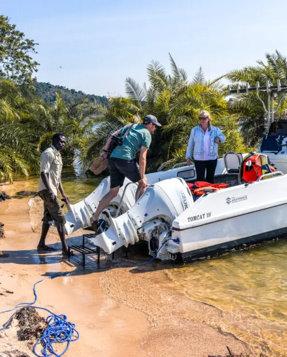 Lake Victoria, boat on shore as guests climb in for boating with guides