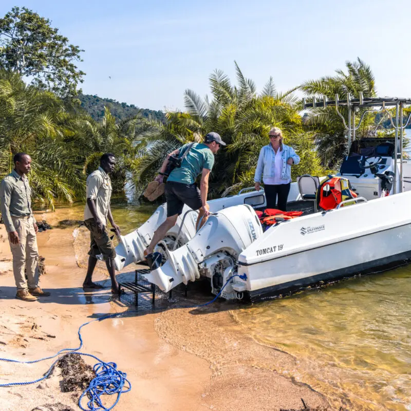 Lake Victoria, boat on shore as guests climb in for boating with guides