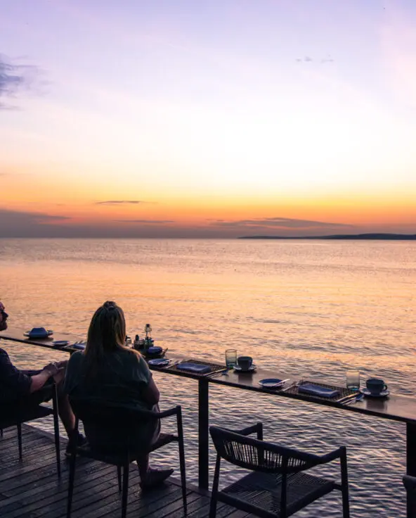 Sunset view over Lake Victoria, couple enjoying drinks