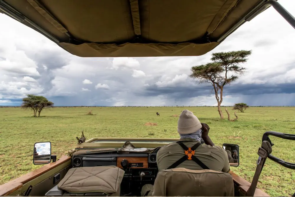 Anderson, searching the Namiri Plains through his binoculars.