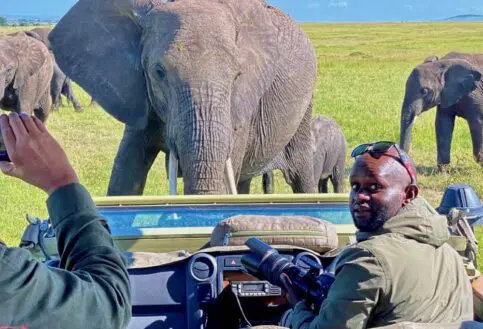 A curious herd of elephant come to inspect Charles's vehicle.