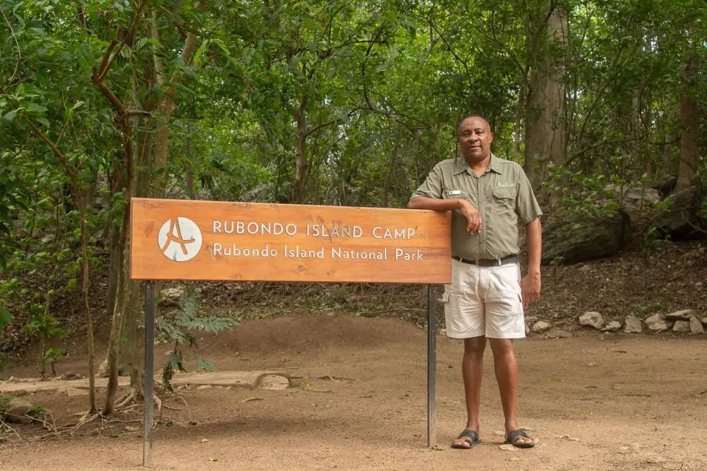 David standing next to the Rubondo Island Camp sign, Rubondo Island National Park, Tanzania.